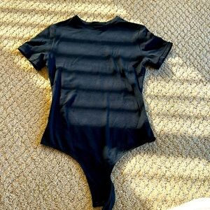 Quince - black short sleeved body suit with thing back and 2 snap closure.